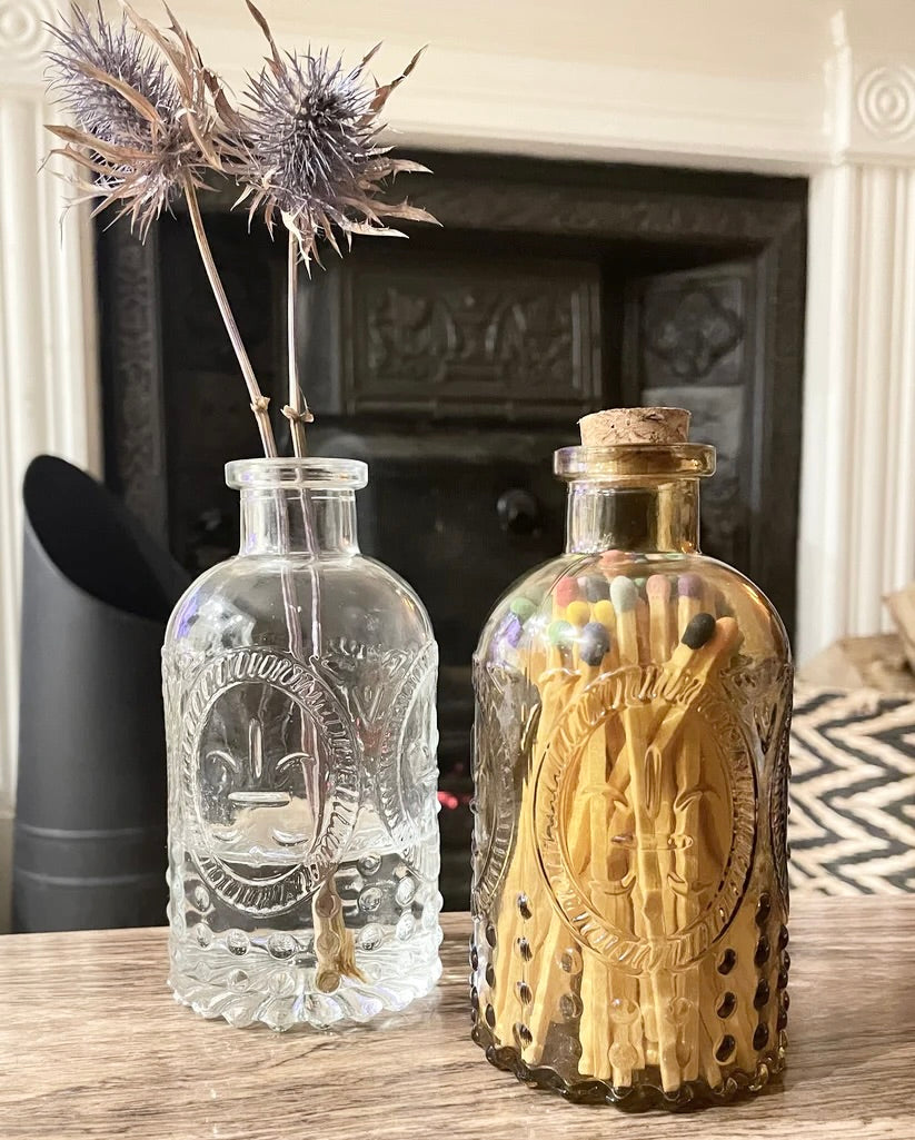 A vintage glass vase with cork, available in clear and amber. These multipurpose jars are perfect for holding matches (sold separately), storing small items, or to display fresh or dried flowers.