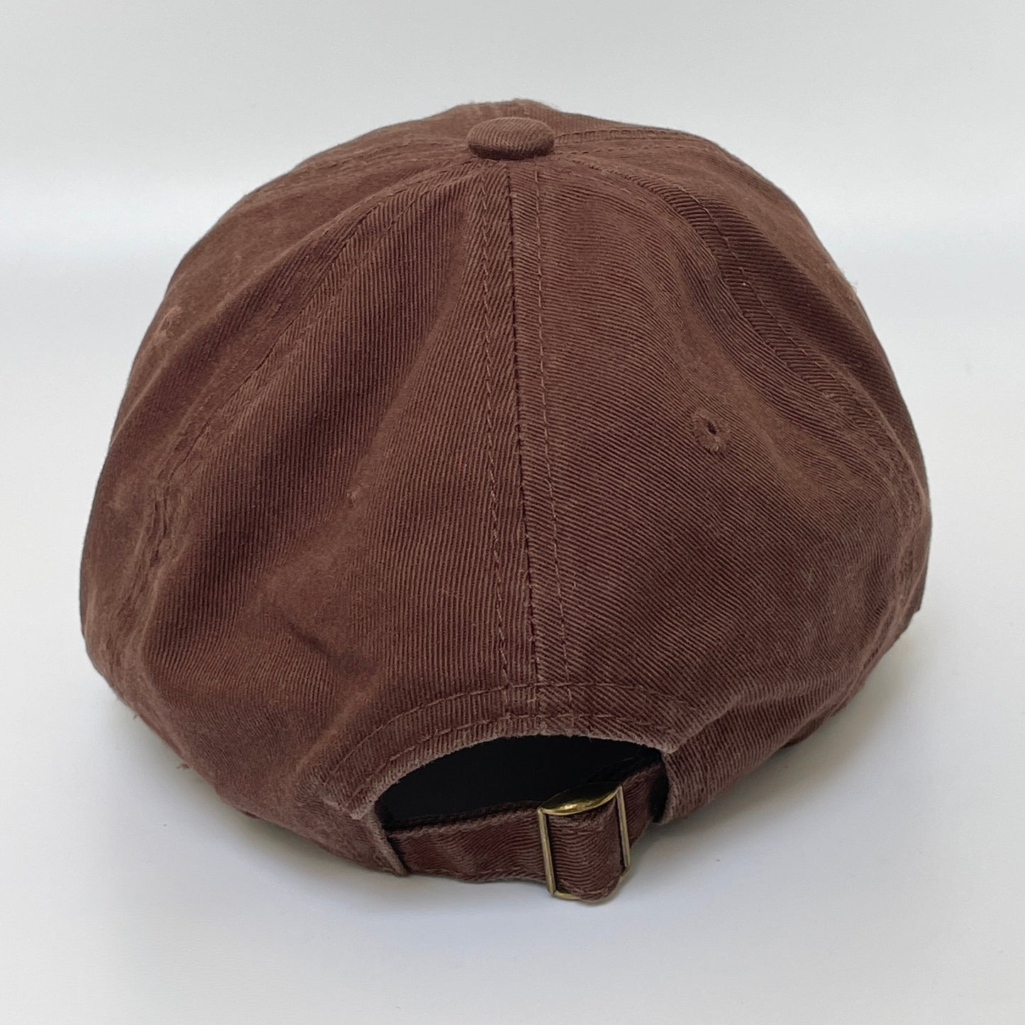 Brown cap with metal clasp on white background.