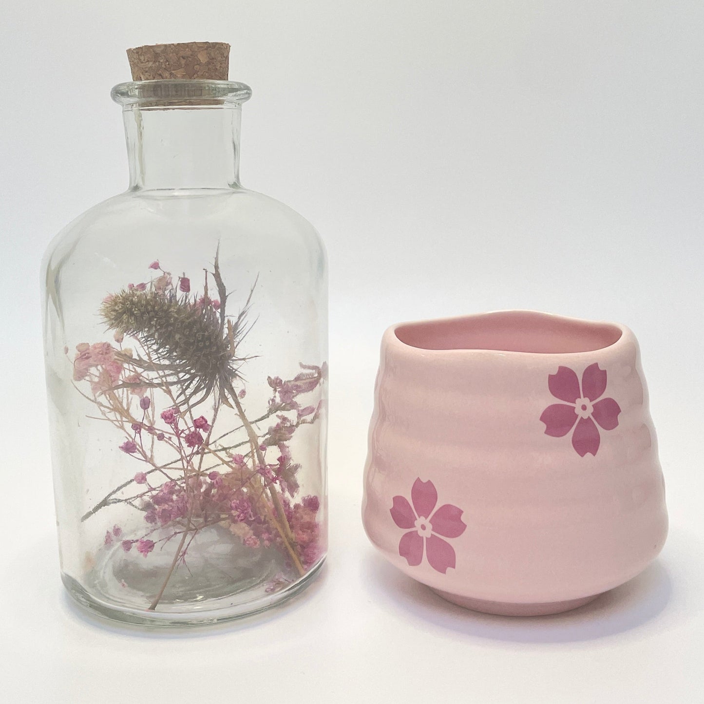 Dried flower apothecary bottle with a match holder that doubles as a coffee or tea cup.