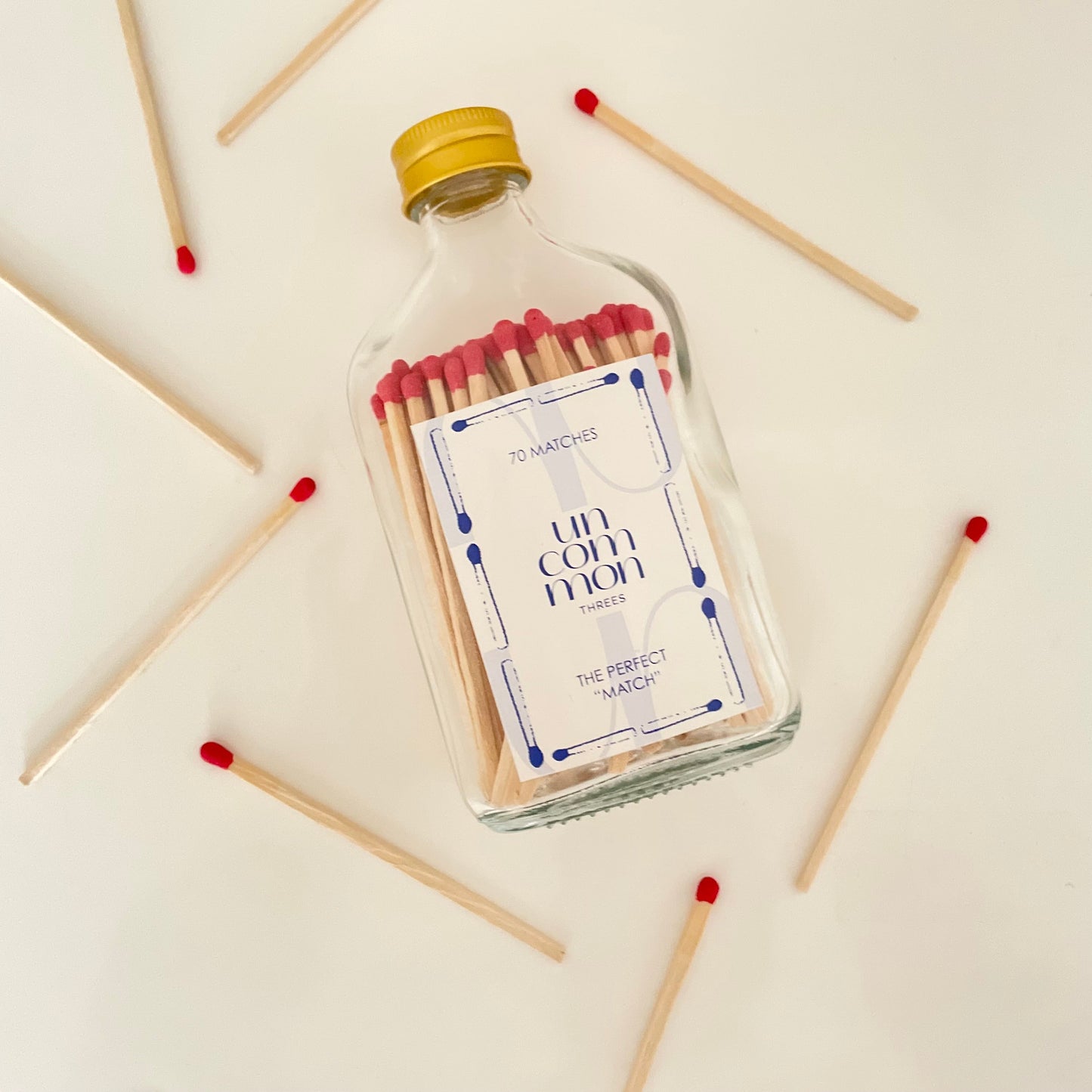 Clear glass bottle filled with dark blue 9.8 cm matches.