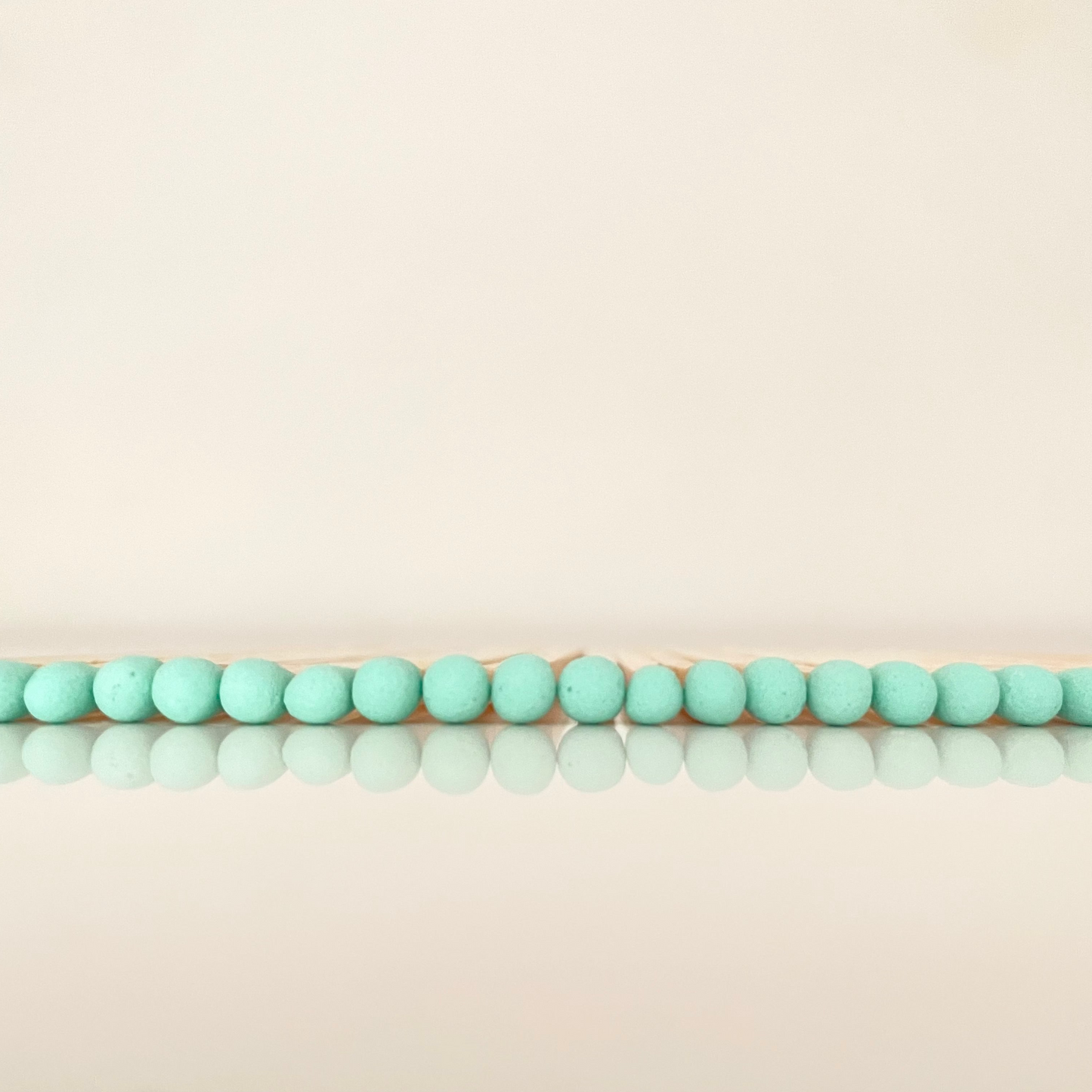 9.8 cm coral matches on white surface.