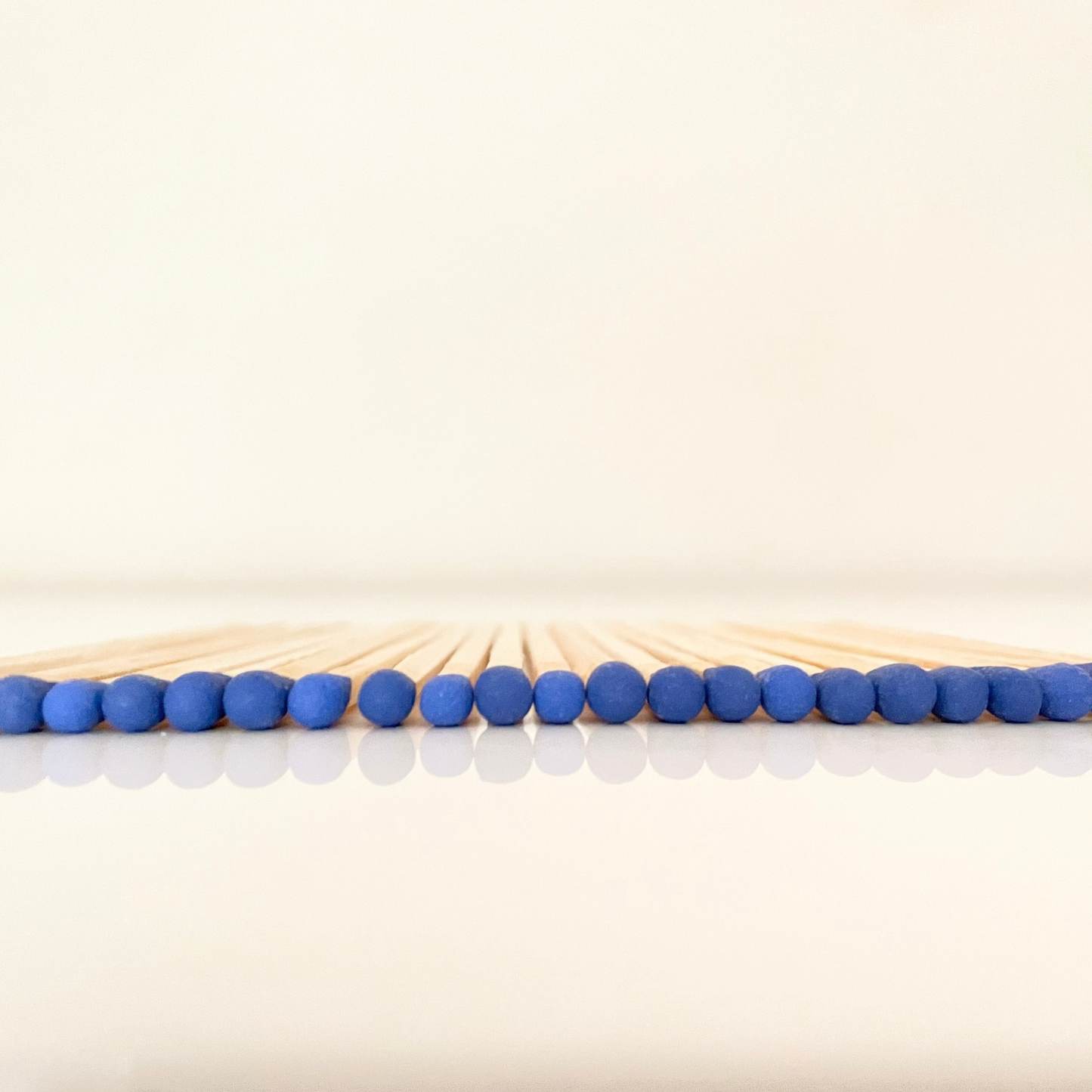 9.8 cm electric blue matches on white surface.