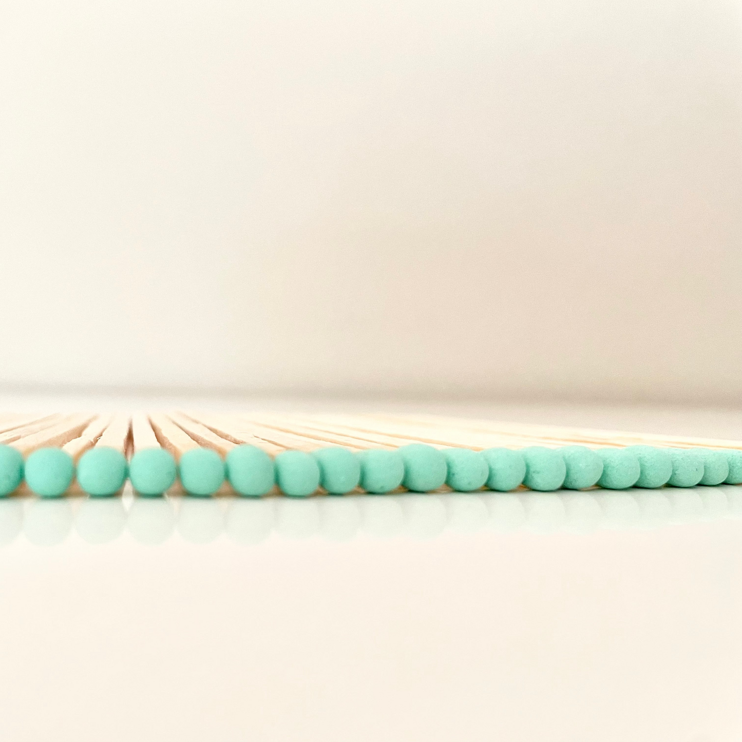 9.8 cm aqua matches on white surface.