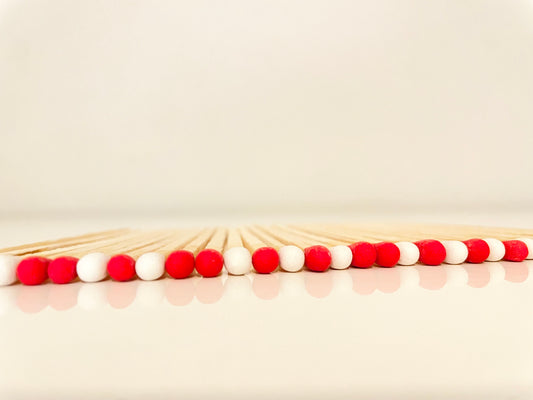 9.8 cm candy cane matches on white surface.
