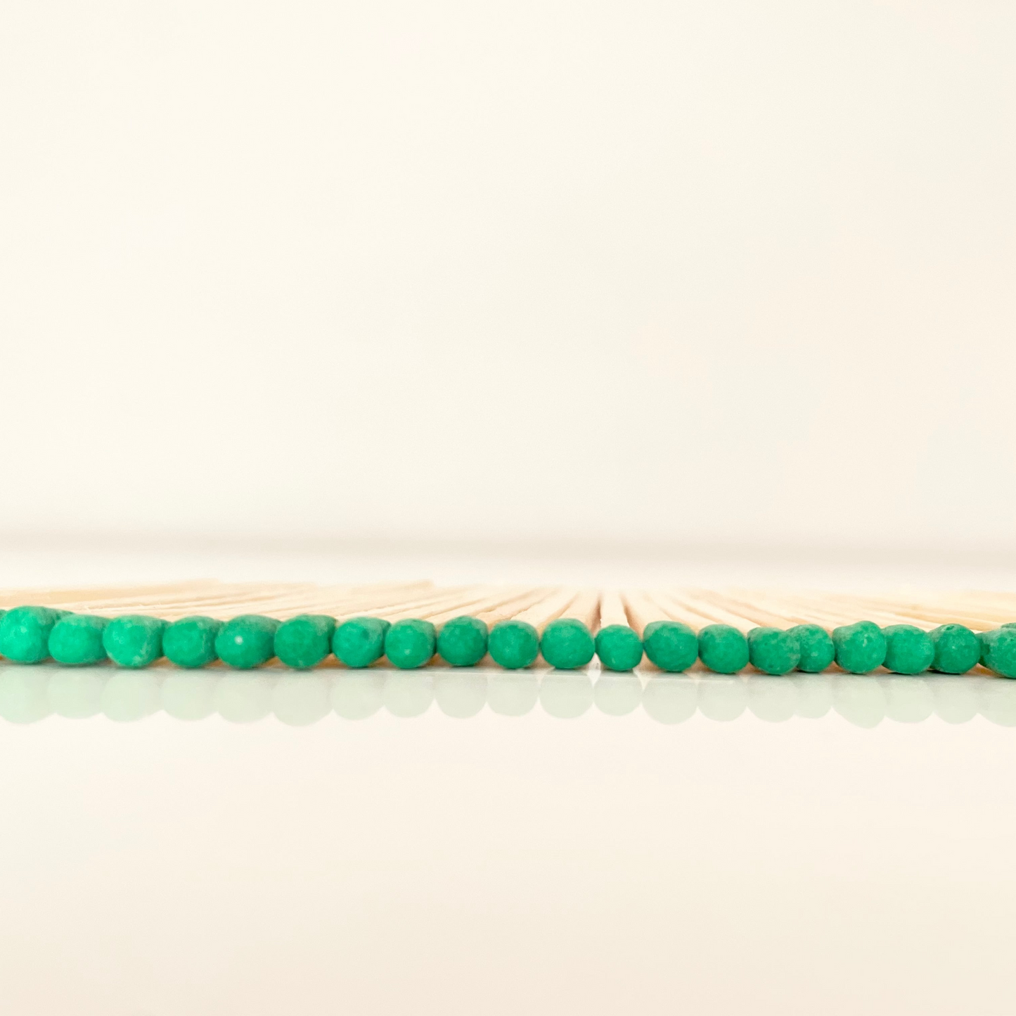 7.5 cm green matches on a white surface.