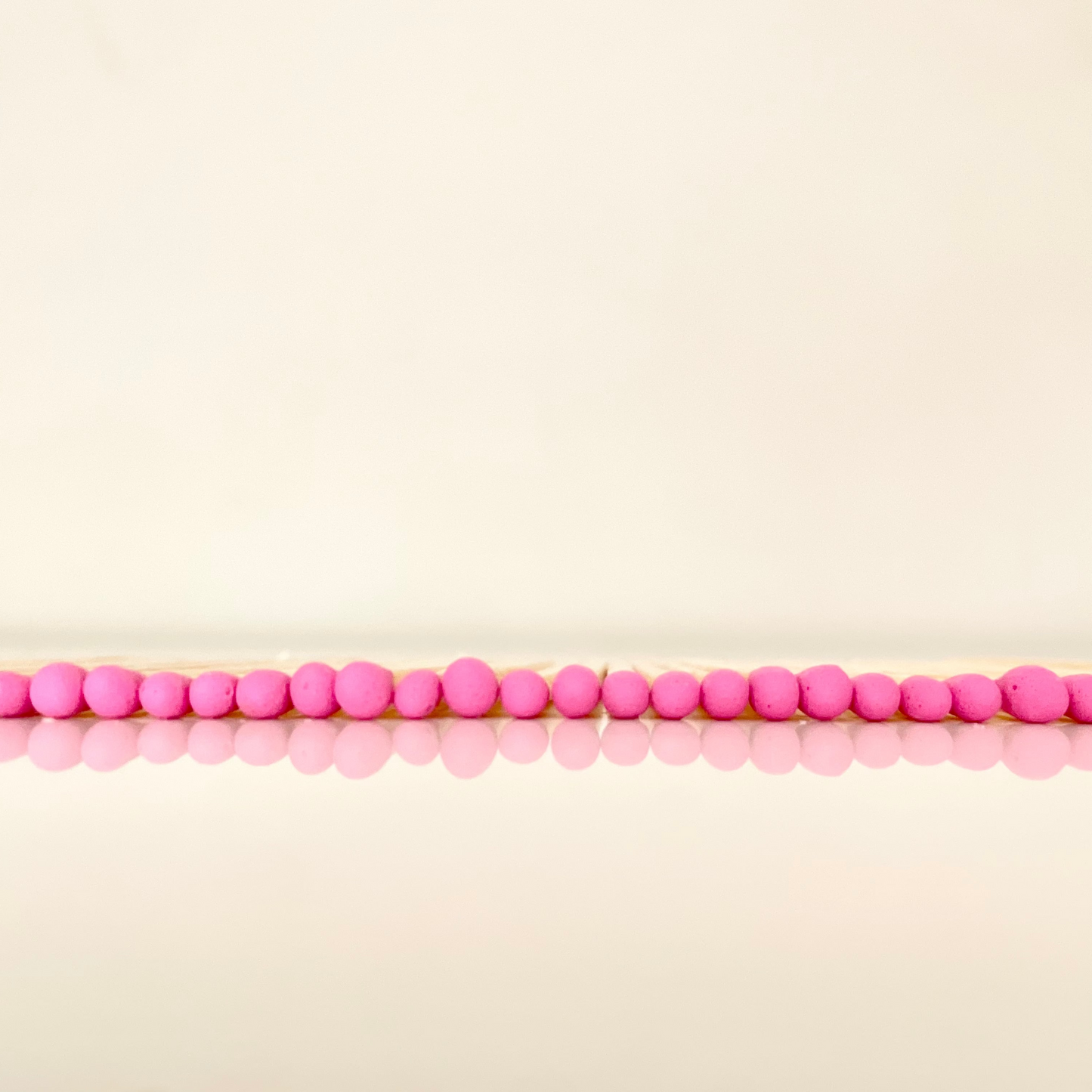 7.5 cm hot pink matches on a white surface.