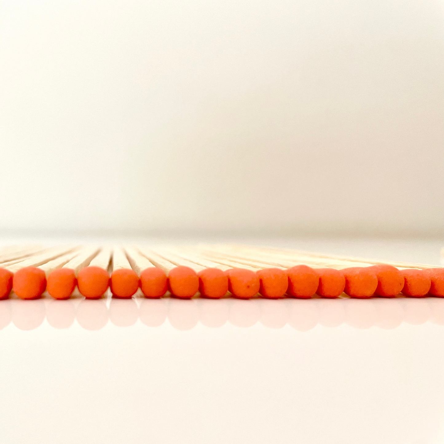 9.8 cm orange matches on white surface.