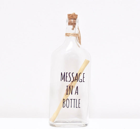 A glass bottle with a message "MESSAGE IN A BOTTLE" and a cork lid, containing a scroll to write your personalised text.