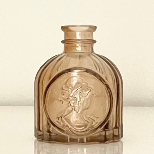 Amber glass mini vase (A) with textured surface on a white background.