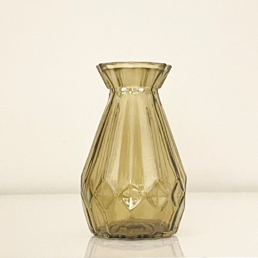 Amber glass vase (B) with textured surface on a white background.
