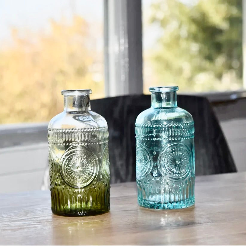 A beautiful vintage glass vase available in blue and green, made from eco-friendly, BPA-free glass. Perfect for table decor, home decor, or as a unique addition to any office space.