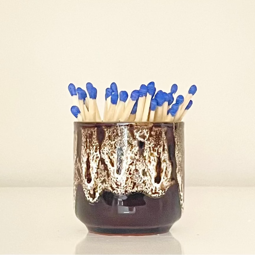White glazed match holder filled with 7.5 cm refill matches (sold seperately) on white surface.