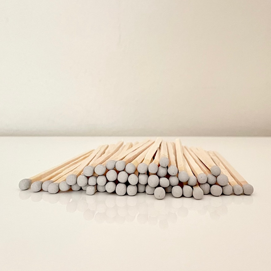9.8 cm grey matches on a white surface. 