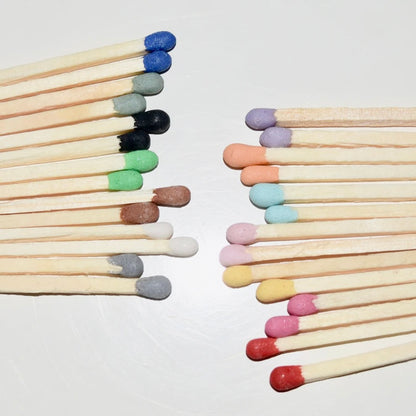 4.8 cm coloured tipped matches on a white surface. 