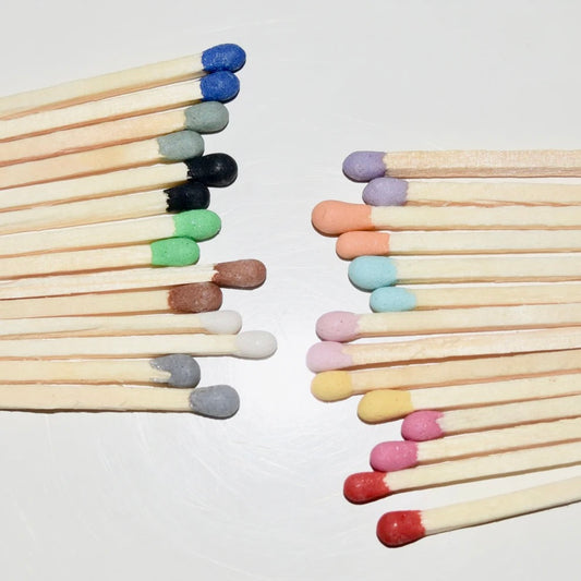 4.8 cm coloured tipped matches on a white surface. 