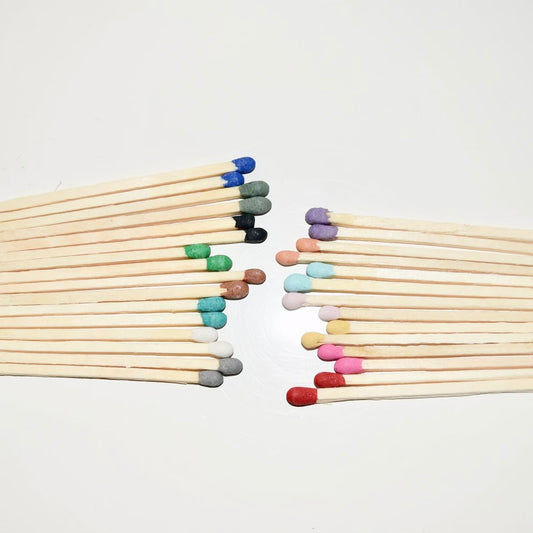 7.5 cm coloured tipped matches on a white surface. 