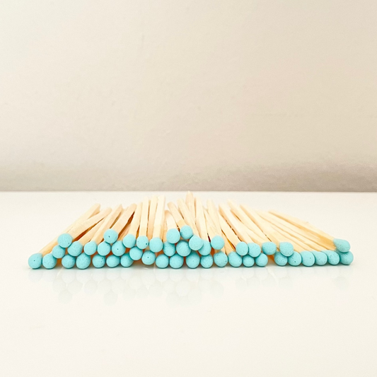 7.5 cm aqua matches on a white surface. 
