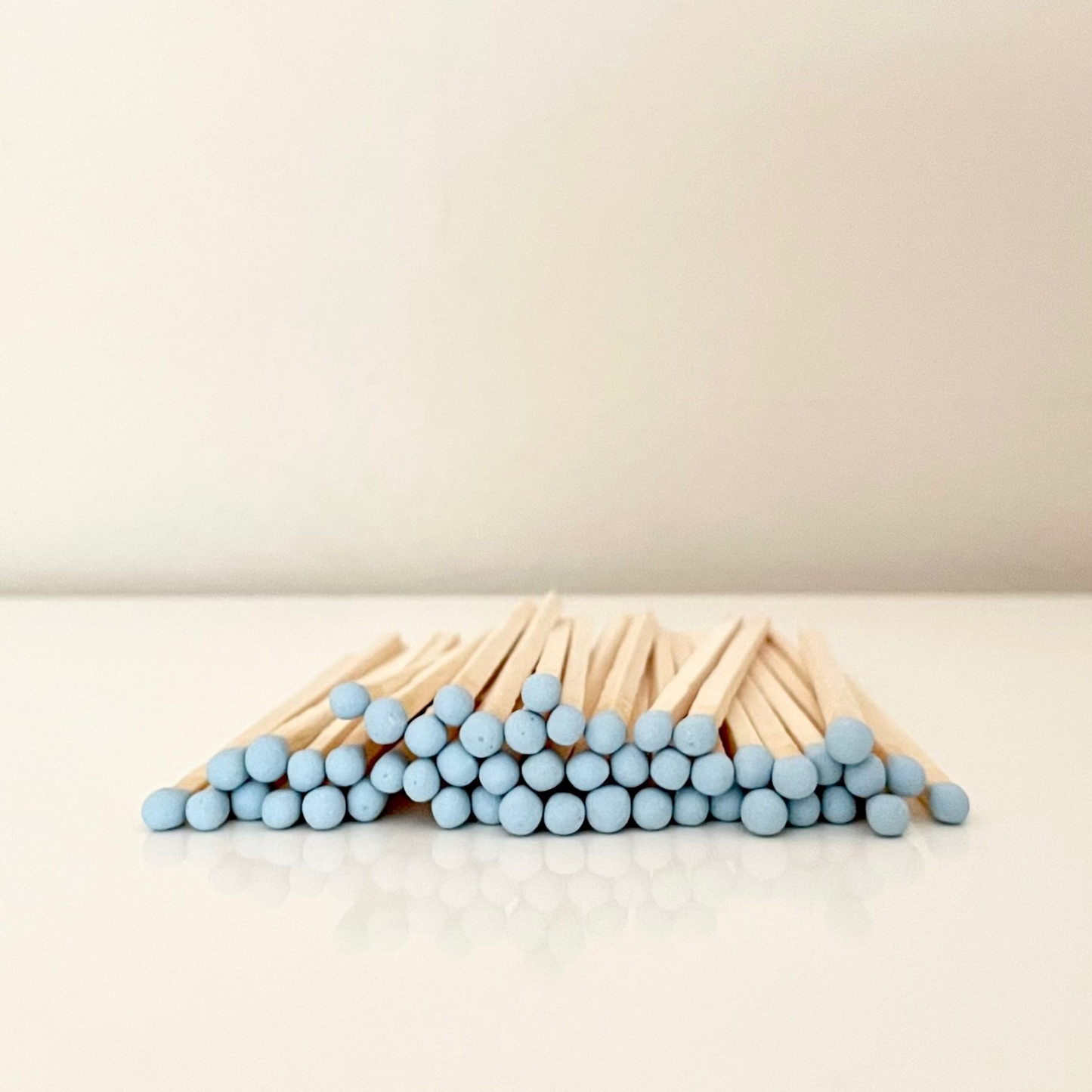 9.8 cm baby blue safety matches on a white surface. 