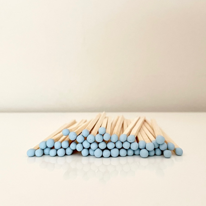 9.8 cm baby blue safety matches on a white surface. 