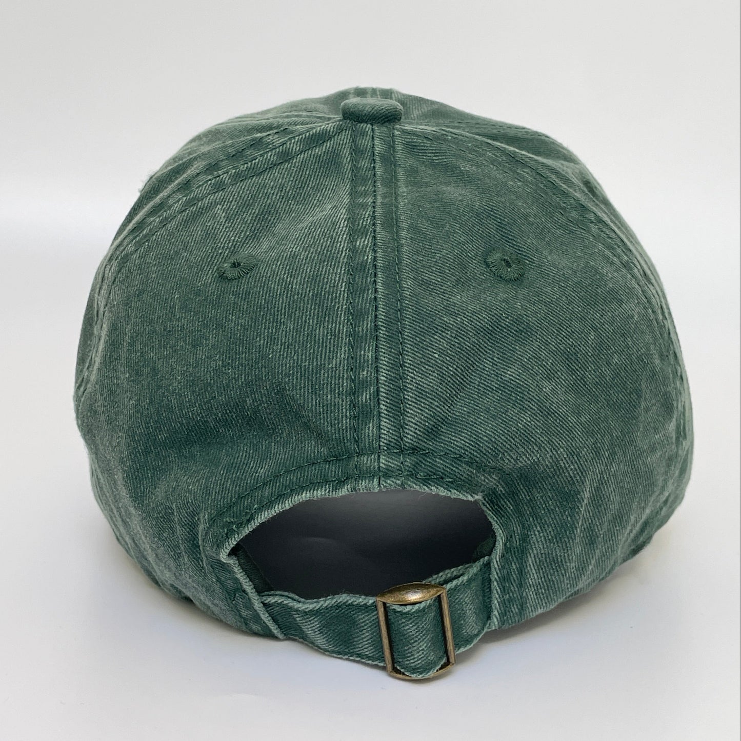 Green cap with metal clasp on white background. 