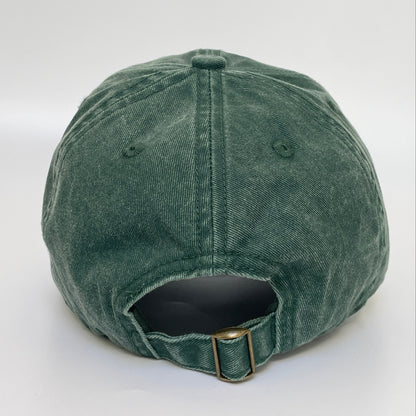 Green cap with metal clasp on white background. 