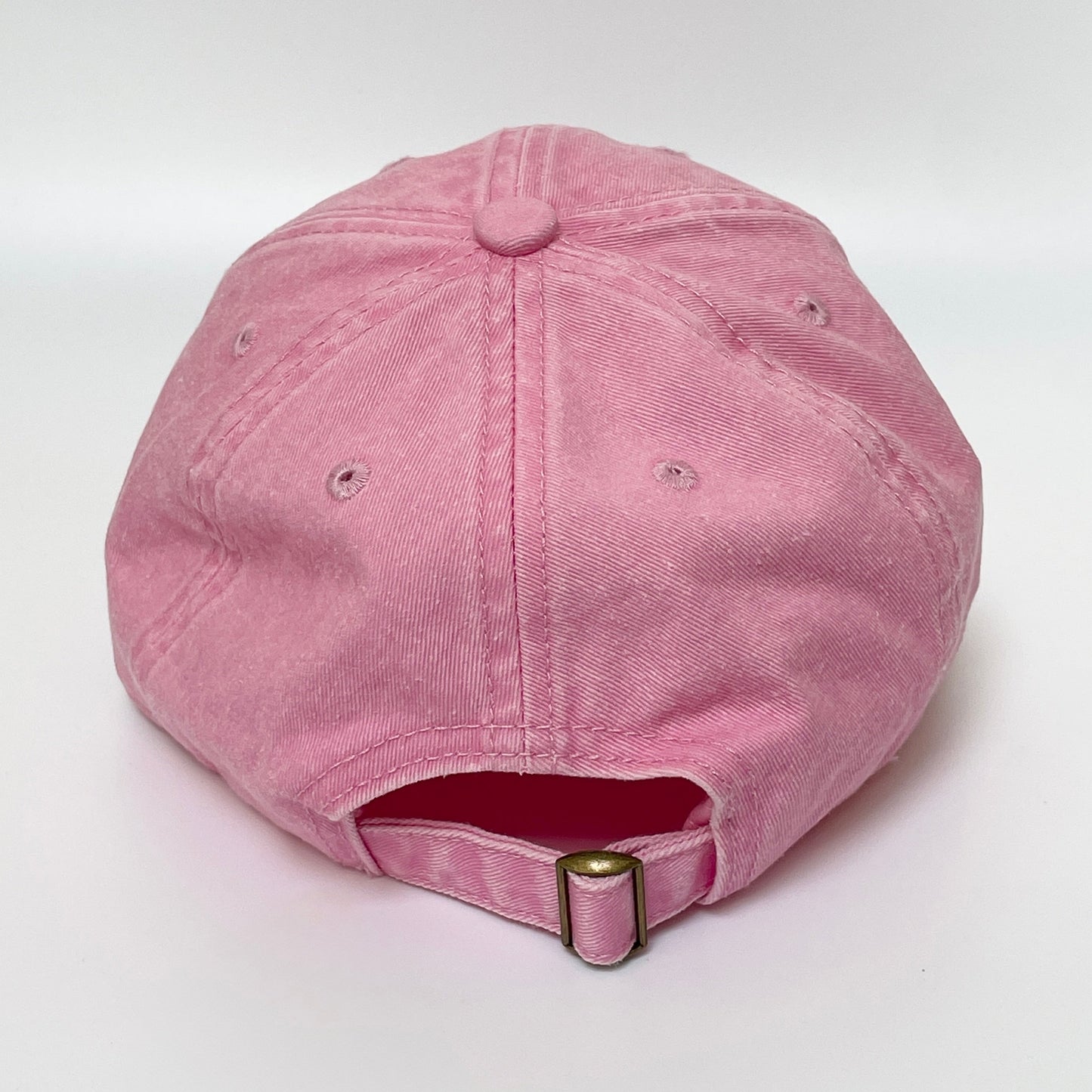 Pink cap with metal clasp on white background. 