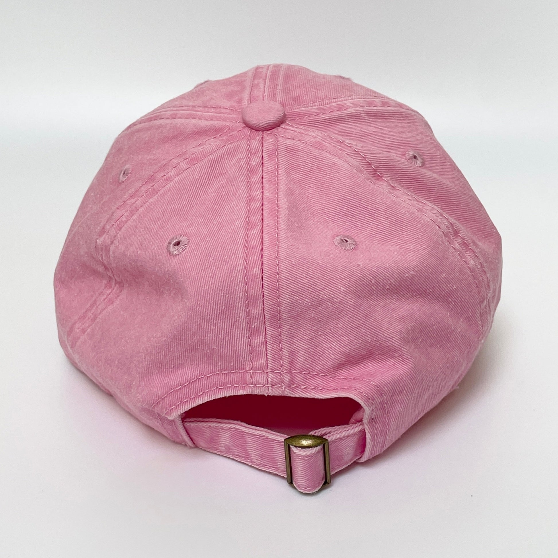 Pink cap with metal clasp on white background. 
