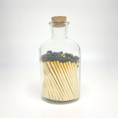 Apothecary match bottle filled with 7.5 cm black matches. 