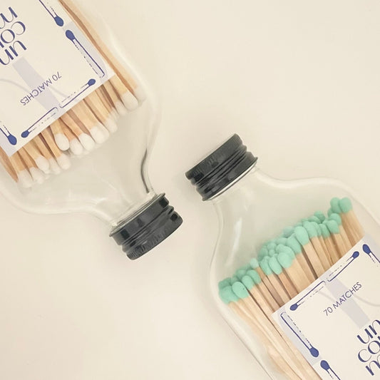 Two black lid match bottles filled with 9.8cm coloured matches.