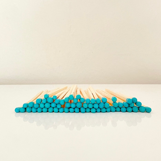 4.8 cm blue matches on a white surface. 