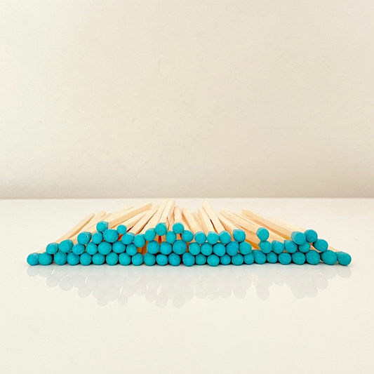 7.5 cm blue matches on a white surface. 