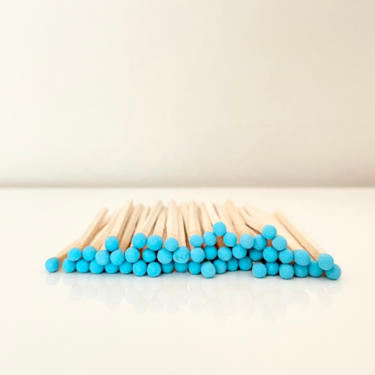 9.8 cm blue matches on a white surface. 