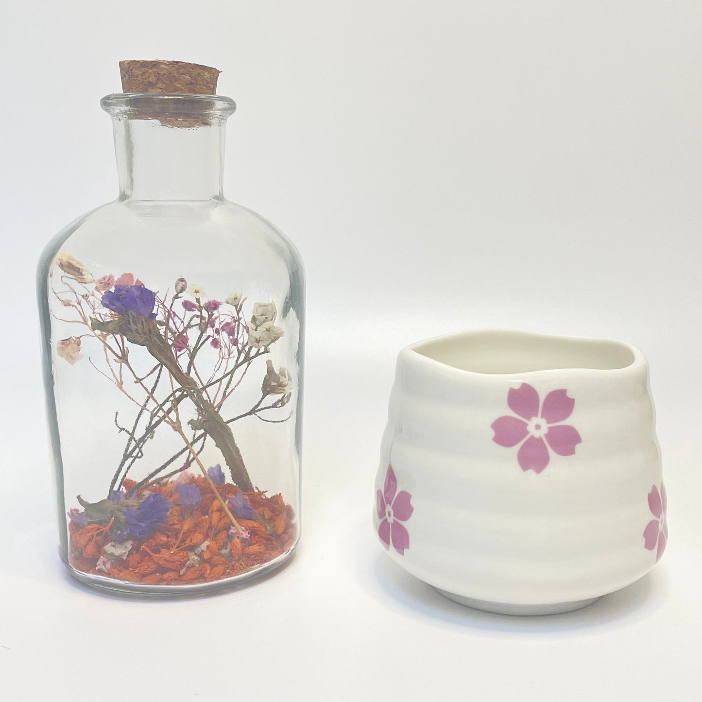 Dried flower apothecary bottle with a match holder that doubles as a coffee or tea cup. 