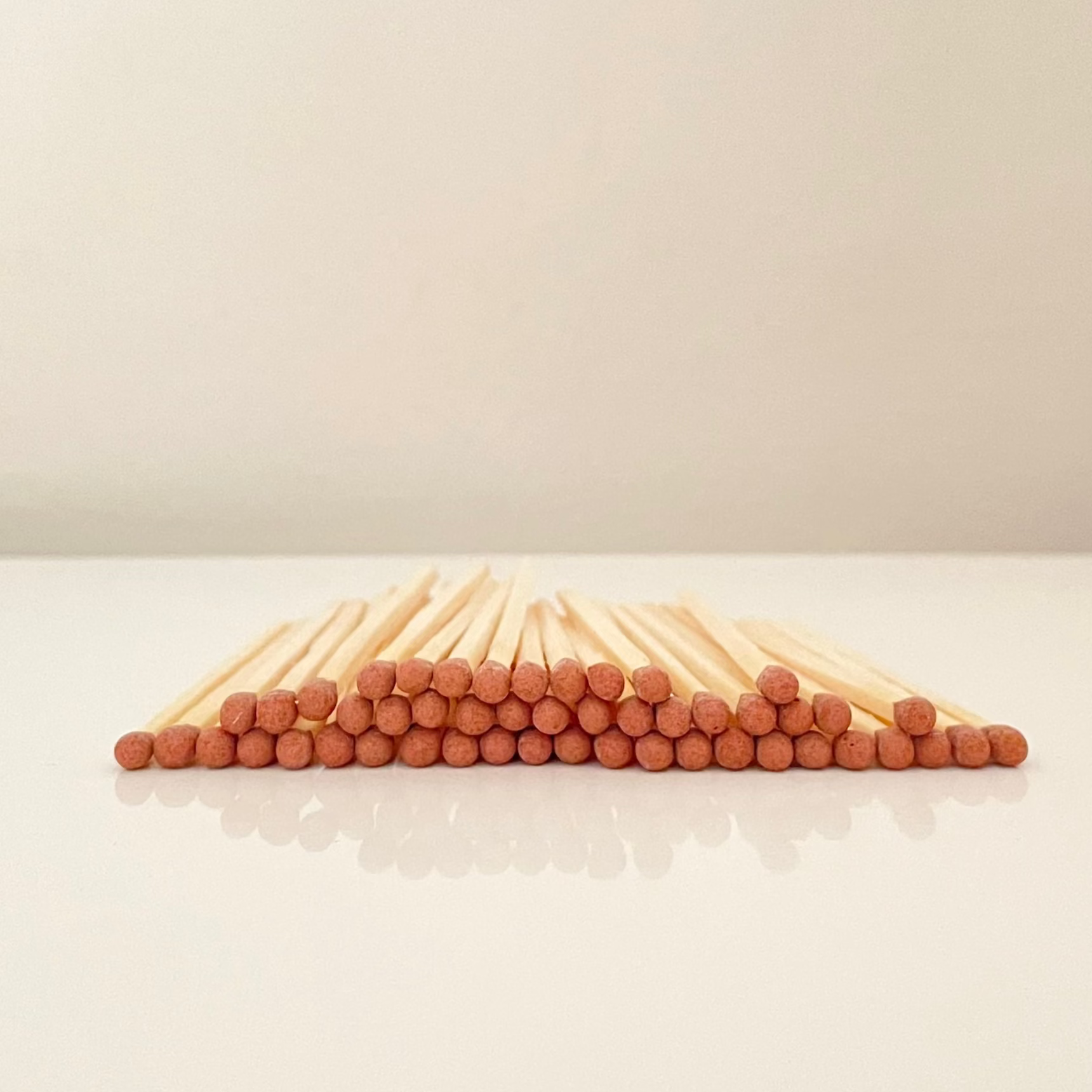 4.8 cm brown matches on a white surface. 