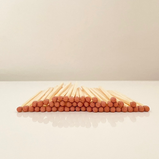 4.8 cm brown matches on a white surface. 