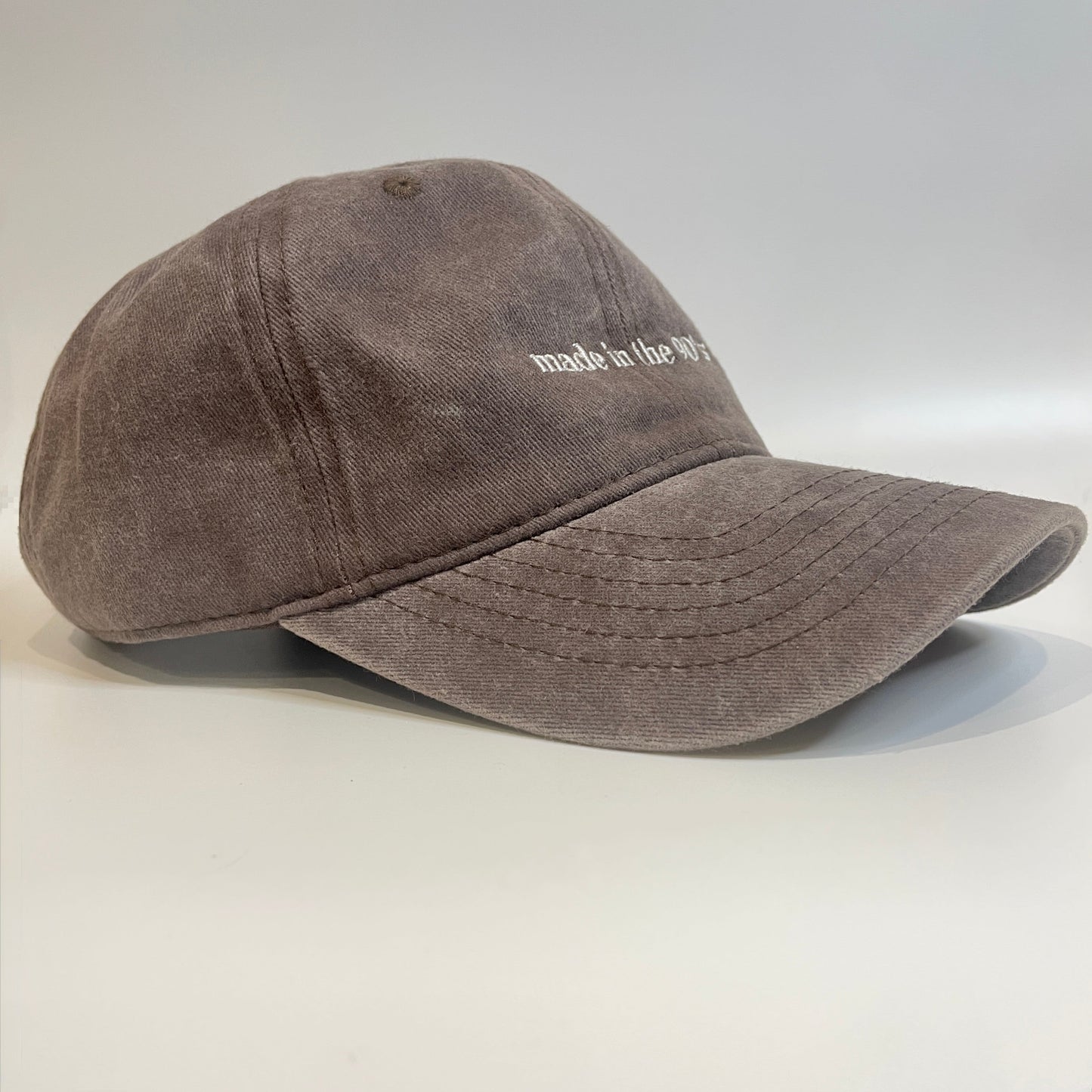 Brown washed cotton cap with 'made in the 90's' embroidery.