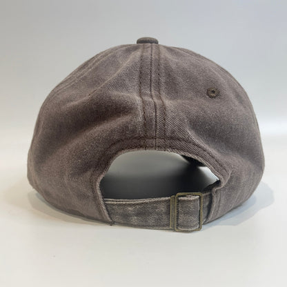 Brown cap with metal clasp on white background. 