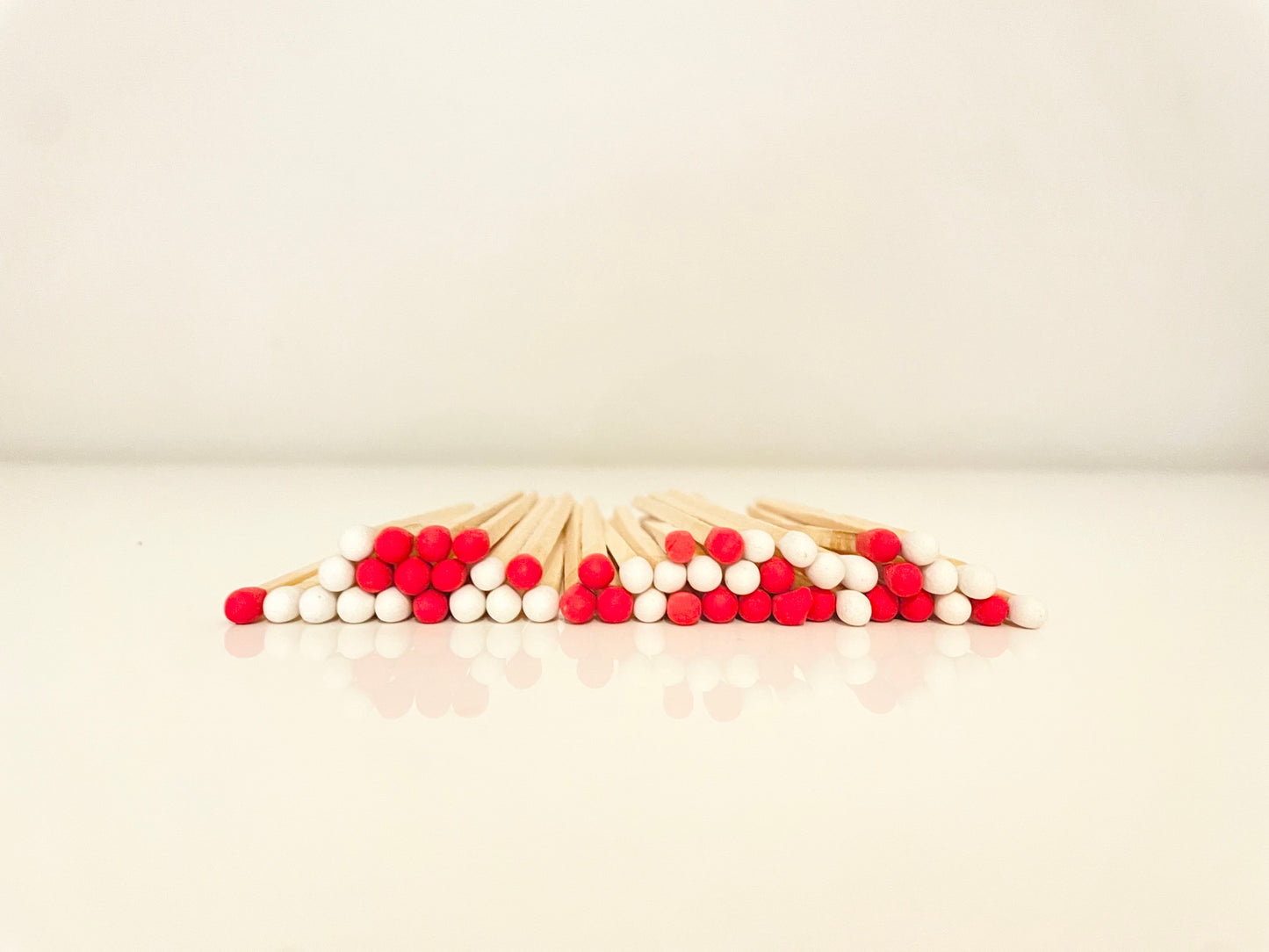 9.8 cm candy cane matches on white surface.