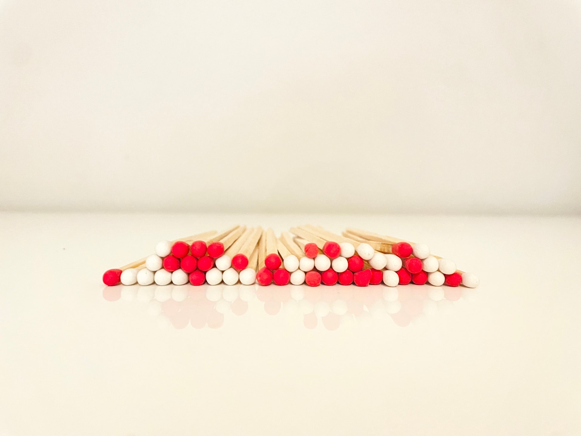 9.8 cm candy cane matches on white surface.