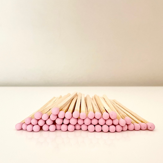 9.8 cm dusky pink matches on a white surface. 