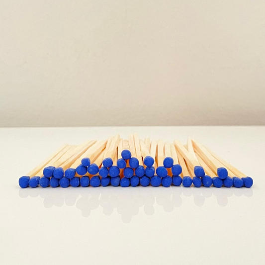 4.8 cm electric blue matches on a white surface. 