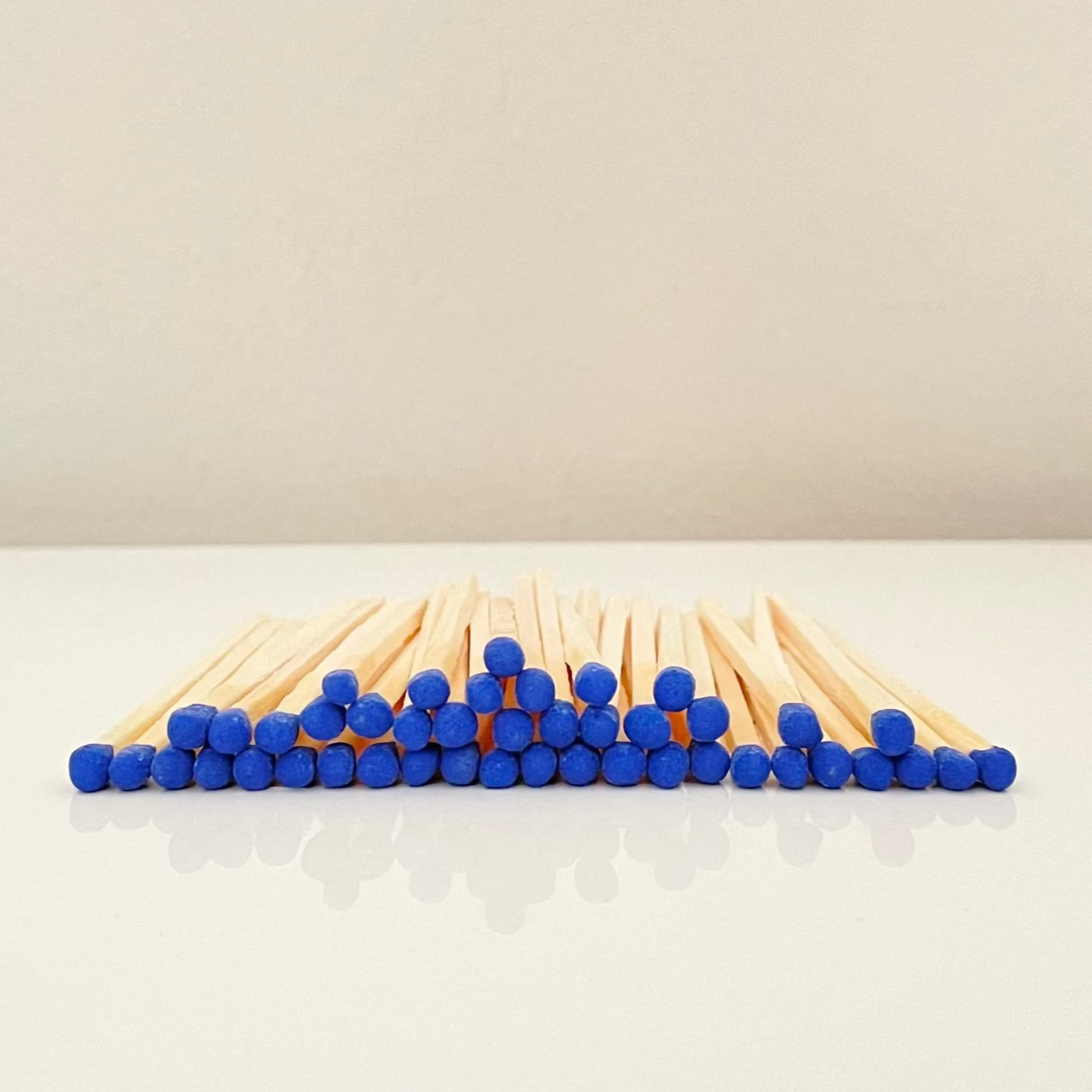 7.5 cm electric blue matches on a white surface. 