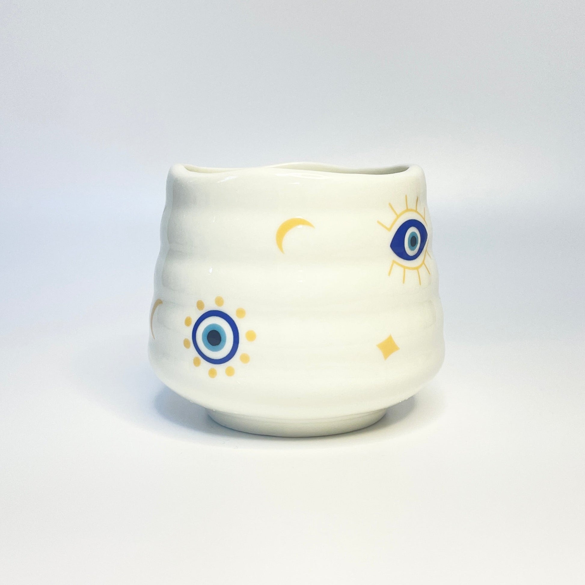 Decorative evil-eye match holder/ coffee cup. 