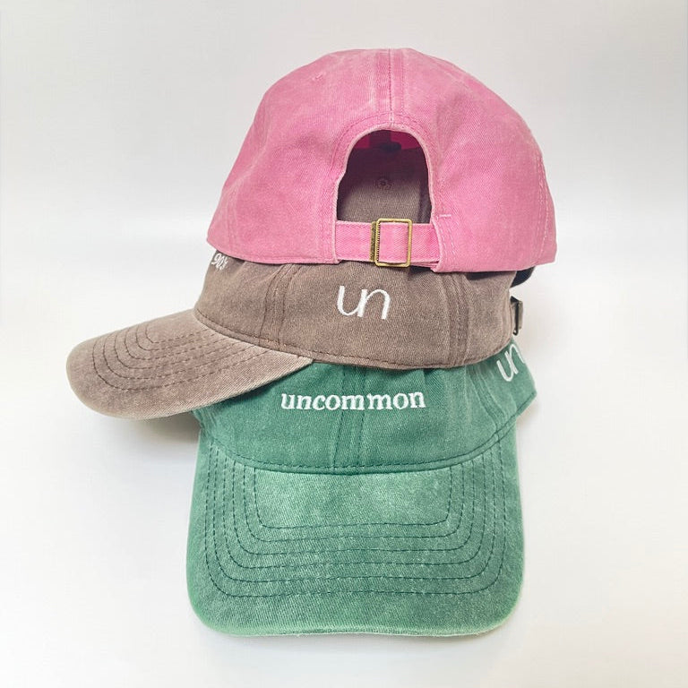 Pink cap with metal clasp on white background. 