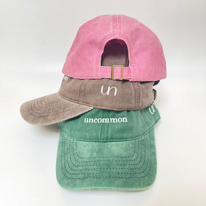 Pink cap with metal clasp on white background. 