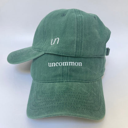 100% Green washed cotton cap with white embroidery and side emblem. 