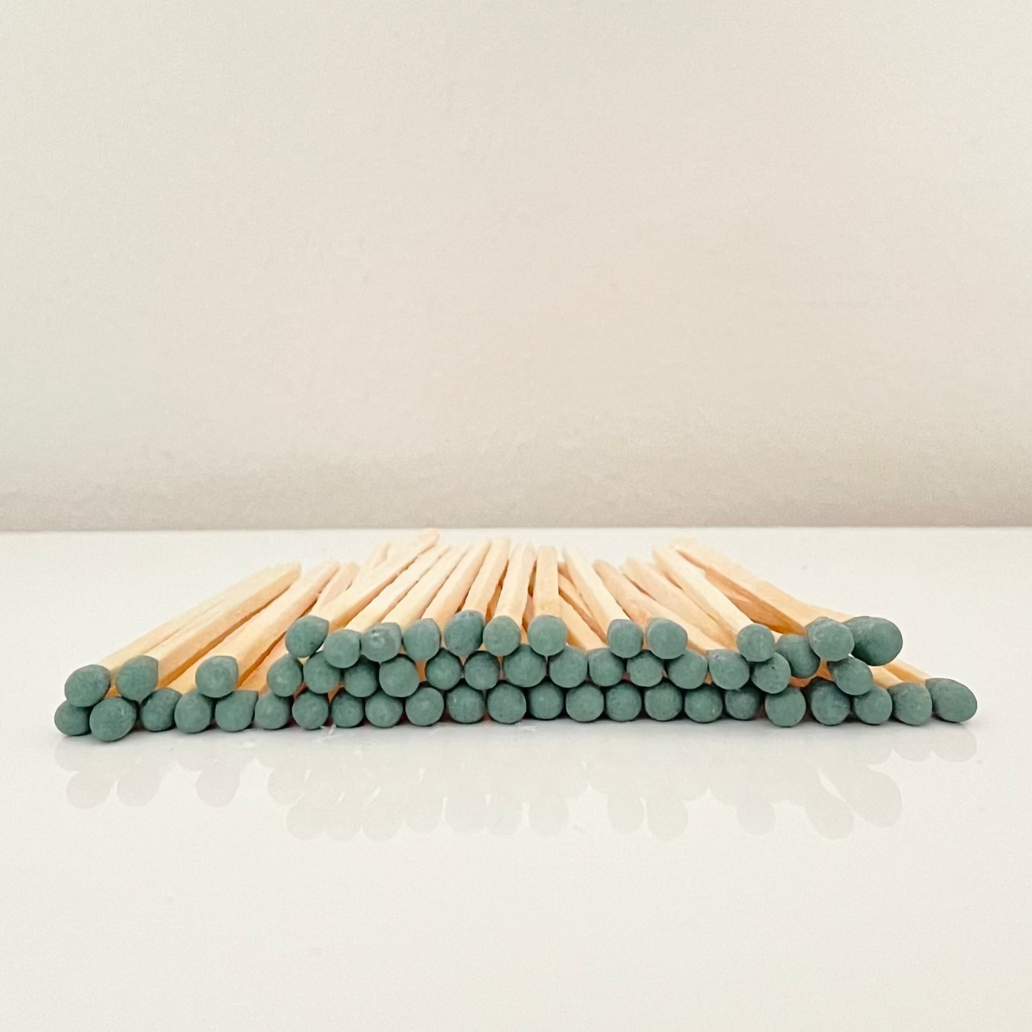 7.5 cm forest green matches on a white surface. 