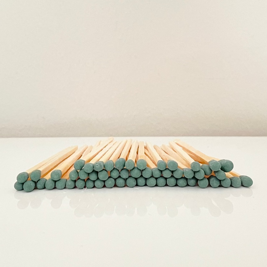 7.5 cm forest green matches on a white surface. 