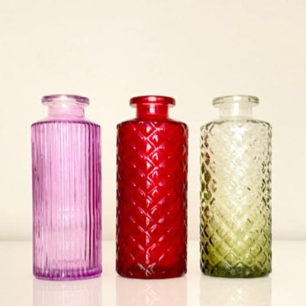 Three textured glass vases with dried plants on a white background.Perfect for displaying fresh or dried flowers, adding a minimalist yet elegant touch to your home decor.