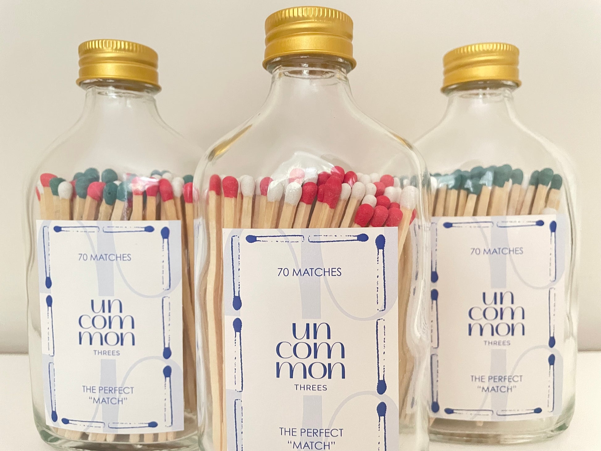 Gold lid glass bottles filled with festive coloured safety matches. The refill matches in this listing are designed to complement these bottles.